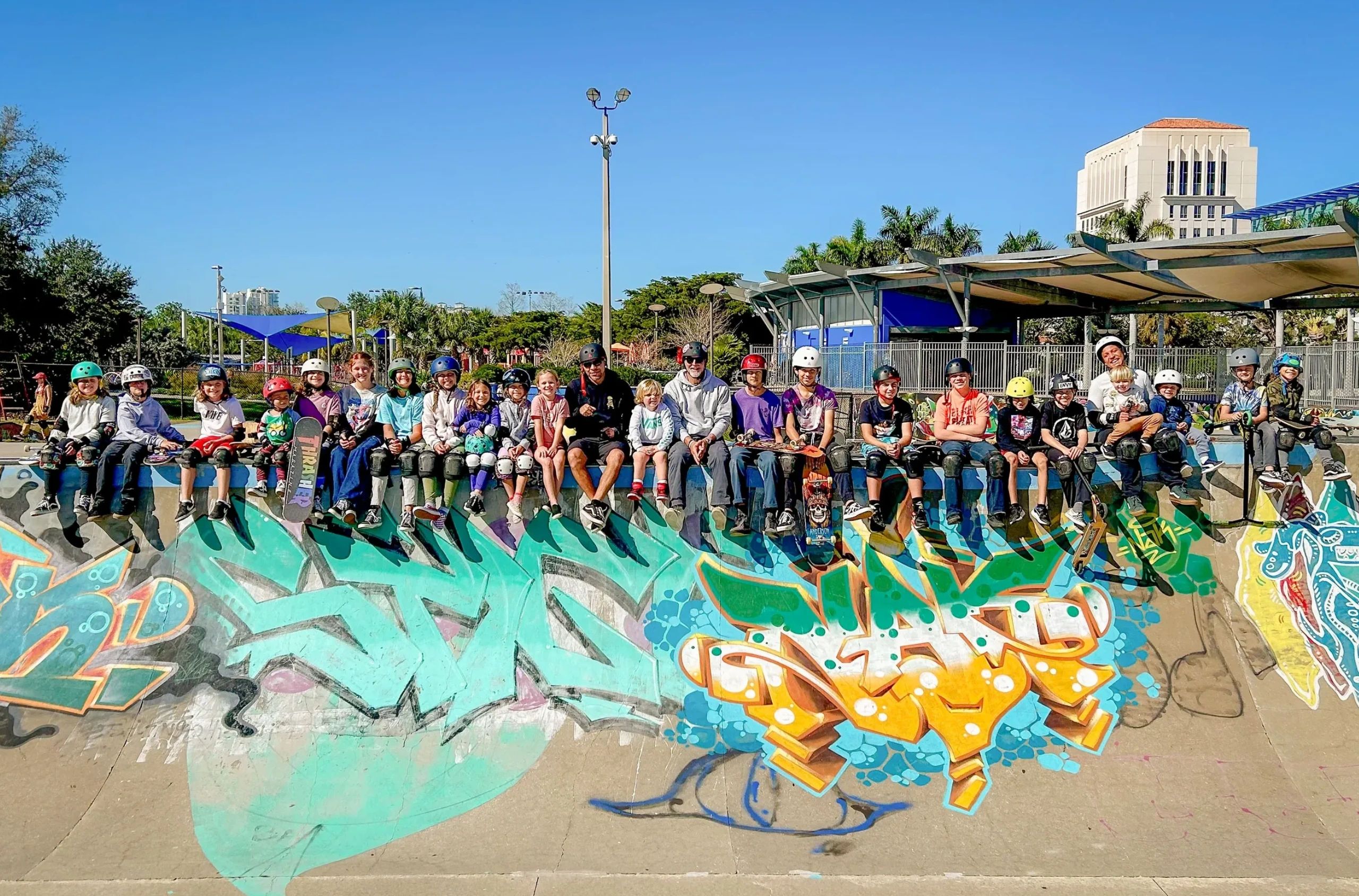 180 Skate kids sitting along a skatepark bowl